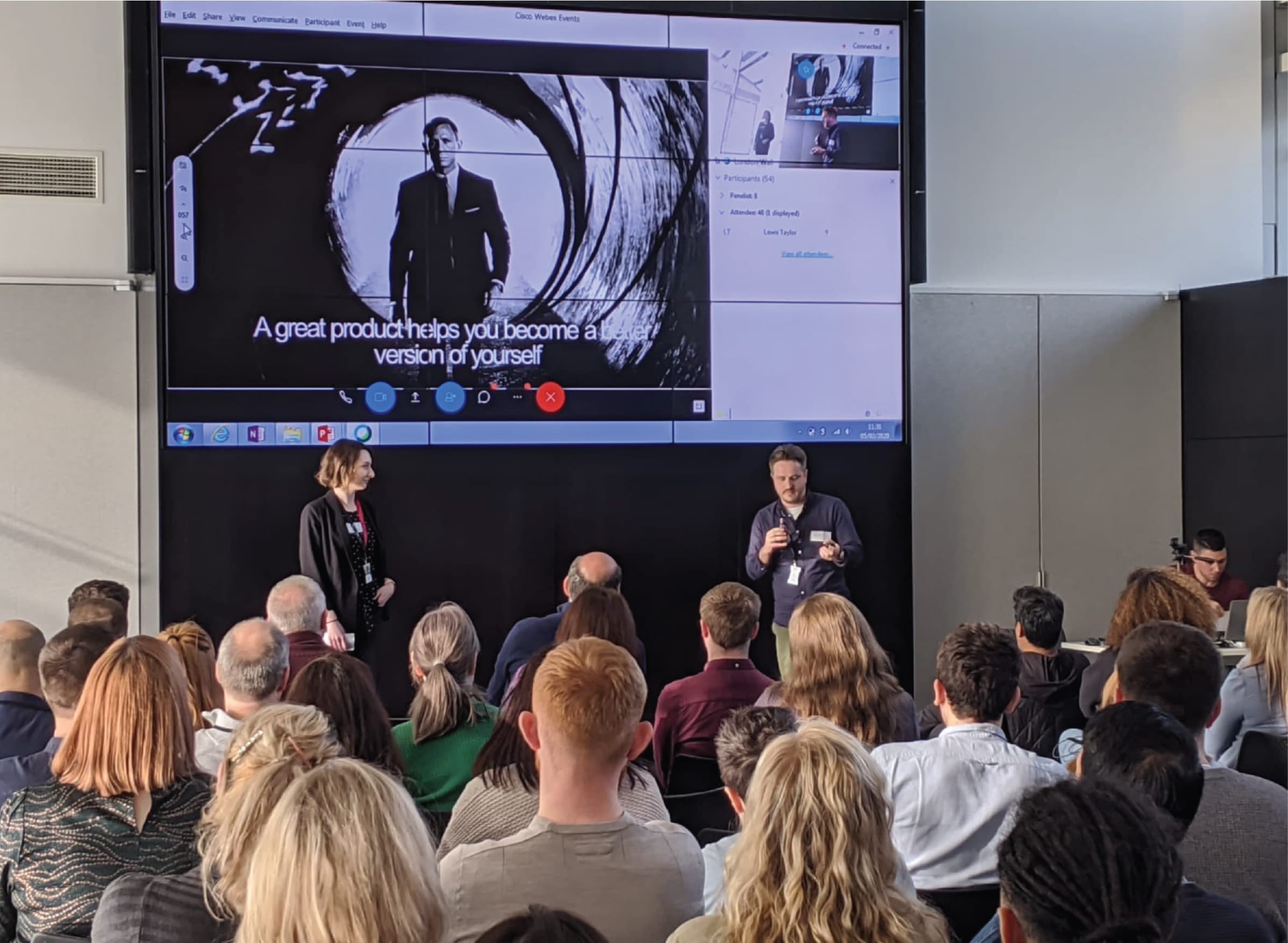 Two people giving a talk to a small crows, the slide says "A great product helps you to become a better version of yourself"